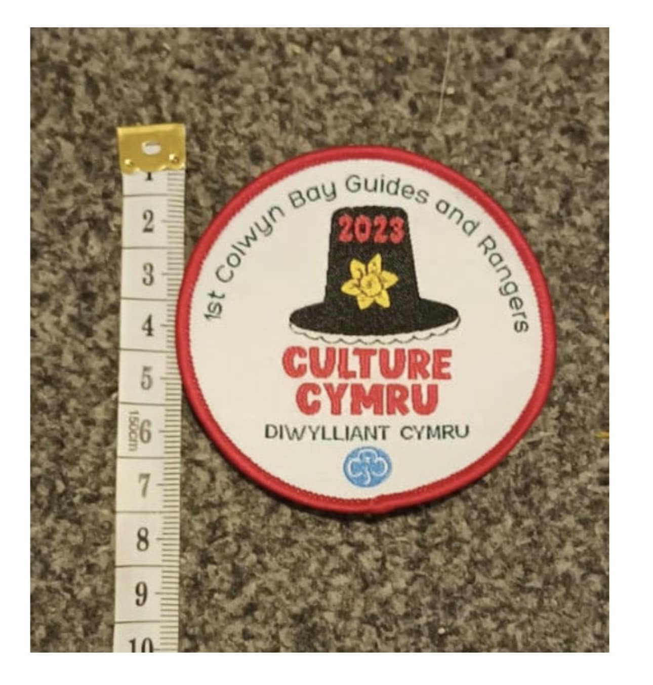 image of the culture cymru badge, it includes the words Culture Cymru and an image of a welsh hat with a daffodil